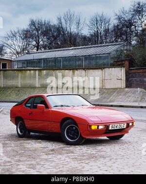 Porsche 924 1977 model year shown in guards red paint and in countryside setting Stock Photo