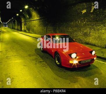 Porsche 944 1985 model year with pop up headlights lit up in an urban tunnel Stock Photo