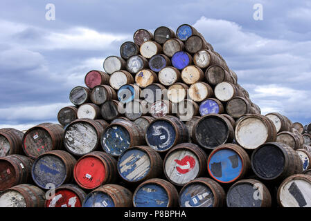 Huge stacks of discarded whisky casks / barrels at Speyside Cooperage, Craigellachie, Aberlour, Banffshire, Grampian, Scotland, UK Stock Photo