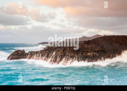 Tourists at Los Hervideros on the west coast of Lanzarote, Canary Islands, Spain Stock Photo