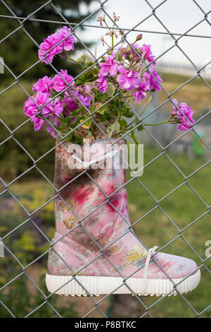 Kids boots filled with plants Stock Photo