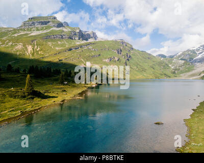 Mountain lake with a green meadow Stock Photo