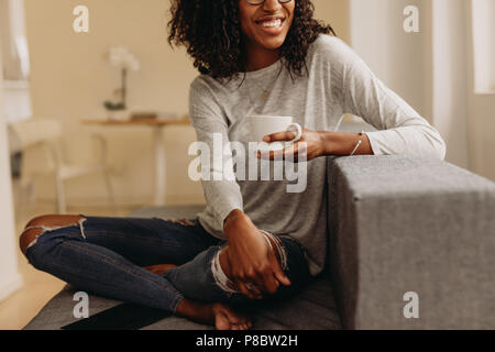 Cropped image of female legs in beige pantyhose and denim jeans standing  half turning back Stock Photo - Alamy