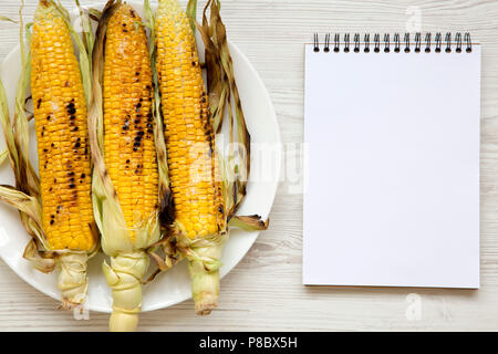 Corn Notepad Grilled corn on the cob with notepad, top view. From above, flat lay ...