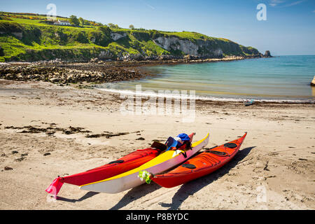 UK, Northern Ireland, Co Antrim, Islandmagee, Portmuck, sea kayaks on beach Stock Photo