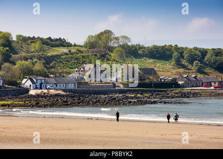 UK, Northern Ireland, Co Antrim, Islandmagee, Browns Bay, visitors walking on the beach Stock Photo