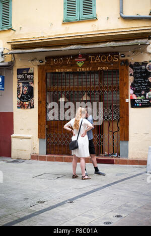 British couple lost in Nice Old Town and looking for directions on phone Stock Photo