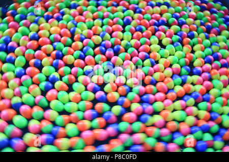 colorful plastic eggs floating on the water background Stock Photo