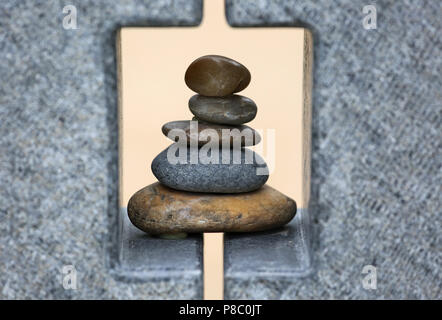 Berlin, Germany, artfully stacked pebbles in a stone frame Stock Photo
