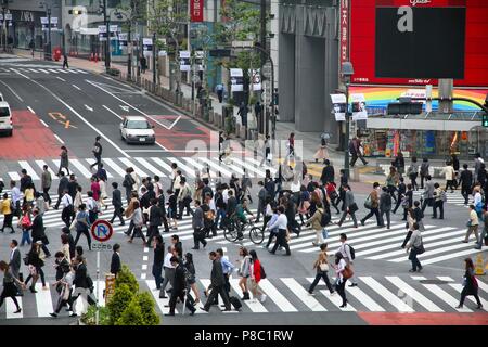 TOKYO, JAPAN - MAY 9, 2012: People walk the Hachiko crossing in Shibuya, Tokyo. Shibuya crossing is one of busiest places in Tokyo and is recognized t Stock Photo