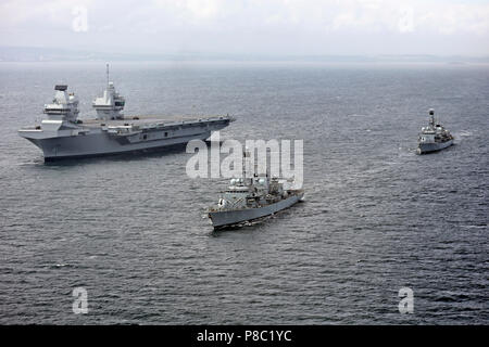 HMS QUEEN ELIZABETH (RO8) aircraft carrier at sea on 28 June 2017 accompanied by  Type 23 frigatesHMS Sutherland (front) and HMS Iron Duke. Courtesy UK Ministry of Defence photo 45162784 Stock Photo