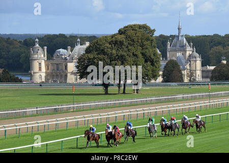Chantilly, France, horses and jockeys during a gallop race in front of the castle Stock Photo