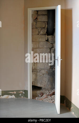 Chantilly, France, masonry and rubble behind an open door Stock Photo