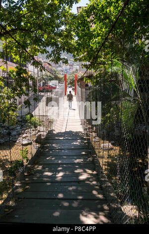 PUERTO VALLARTA, MEXICO - March 10, 2018: Walking along the suspension bridge from Isla Rio Cuale in downtown Puerto Vallarta , MX-JAL. Stock Photo