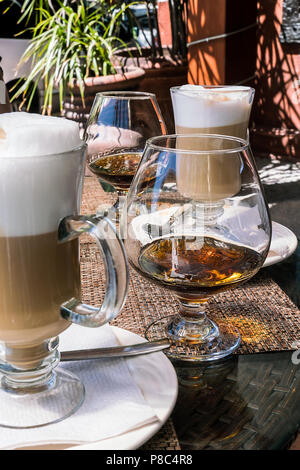 PUERTO VALLARTA, MEXICO - MARCH 10, 2018: Relax with a frothy coffee and brandy on a patio cafe, Puerto Vallarta, Spring 2018, MX-JAL. Stock Photo