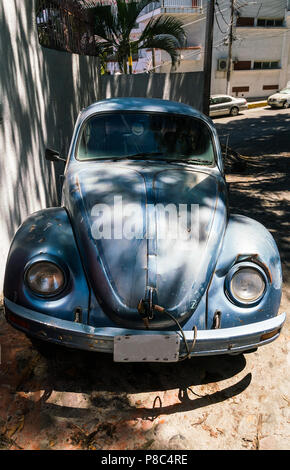 PUERTO VALLARTA, MEXICO - MARCH 10, 2018: An old classic Volkswagen Beetle, in rough condition, with a yellow smiley face hanging in the front window  Stock Photo