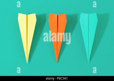 Flat lay set colorful paper plane on pastel turquoise background. Top view creative travel background concept Stock Photo