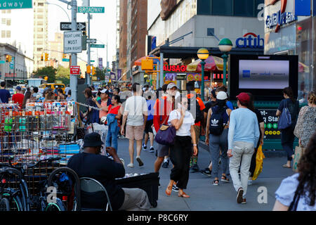 People, and street vendors on a busy, and crowded sidewalk opposite Union Square in Manhattan, New York, NY. (July 10, 2018) Stock Photo