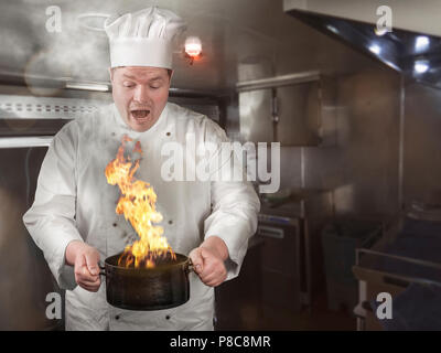cook burns the food in the cooking pot Stock Photo