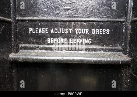 Notice regarding dress code inside an old disused Victorian gentlemens urinal in Somerset England UK Stock Photo