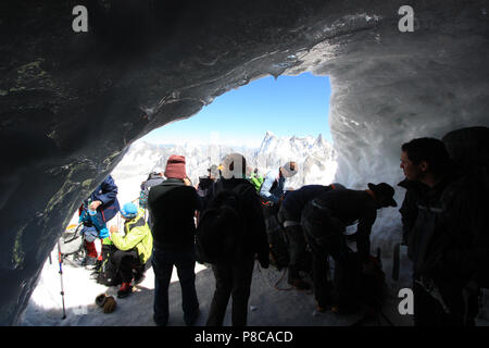 People waiting at this icy place for the arrival of their family members and friends, who are climbing the Aiguille-du-Midi in the Mont Blanc massif Stock Photo
