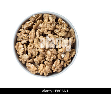 Walnut kernels in a bowl, isolated on white background, top view. Stock Photo