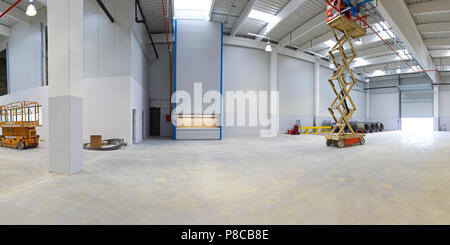 New factory hall with hydraulic scissors lift platform Stock Photo