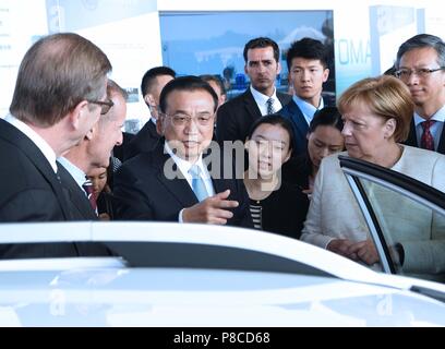 Berlin, Germany. 10th July, 2018. Chinese Premier Li Keqiang and German Chancellor Angela Merkel attend an autopilot cooperation exhibition between the two countries in Berlin, Germany, July 10, 2018. Credit: Rao Aimin/Xinhua/Alamy Live News Stock Photo
