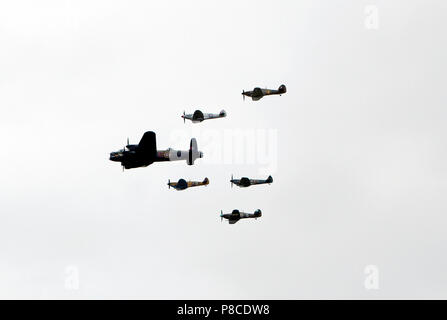 Lancaster, Hurricane and Spitfire Aircraft fly in formation over the Queen Elizabeth  Olympic Park  as part of the RAF Centennial Celebrations Stock Photo