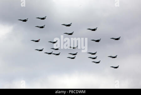 RAF Typhoons  fly over the Queen Elizabeth  Olympic Park in a 100 formation, as part of the Centenary Celebrations Stock Photo