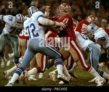 Dallas Cowboys Ed Too Tall Jones talks with the Houston Oilers Earl  Campbell after the game. Football has taken a toll on the body of the  former running back. (Photo by File