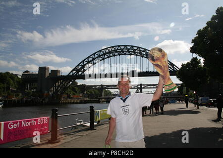 Newcastle upon Tyne, UK. 10th July, 2018. World cup fever grips England. England fans pose with cardboard cutout world cup trophy on the streets of Newcastle. Newcastle upon Tyne, UK. 10th July, 2018. Credit: David Whinham/Alamy Live News Stock Photo