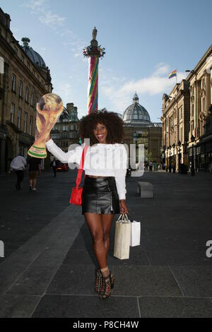Newcastle upon Tyne, UK. 10th July, 2018. World cup fever grips England. England fans pose with cardboard cutout world cup trophy on the streets of Newcastle. Newcastle upon Tyne, UK. 10th July, 2018. Credit: David Whinham/Alamy Live News Stock Photo