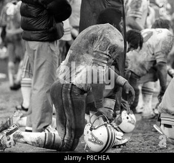 Houston Oilers Earl Campbell (34) is hauled down by Raiders Ted Hendricks  (83) after seven years