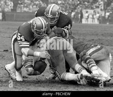 Houston Oiler running back Earl Campbell (34), pops the line for three  yards in the second quarter of the NFL game at Houston, Sunday, Dec. 24,  1979. Houston Oilers David Carter, blocks