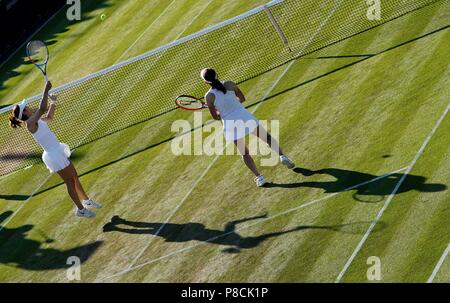 Li Na (L) of China and Ai Sugiyama of Japan compete during the ladies' invitation doubles third round match against Tracy Austin of the United States and Anne Keothavong of Britain at the Wimbledon Championships 2018 in London, Britain, on July 10, 2018. Li Na and Ai Sugiyama won 2-0. (Xinhua/Guo Qiuda) Stock Photo