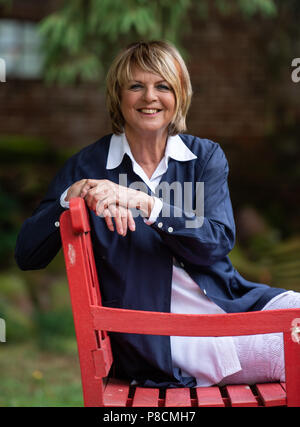 Buechten, Germany. 25th June, 2018. The presenter Alida Gundlach sits on a bench in her garden. Gundlach celebrates her 75th birthday on 17 July. Credit: Philipp Schulze/dpa/Alamy Live News Stock Photo