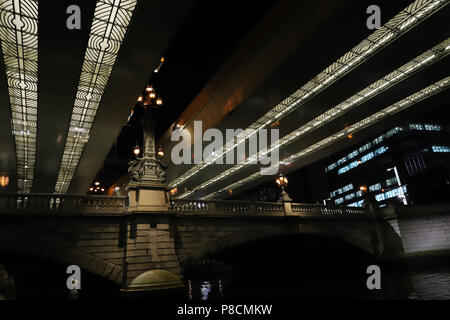 Tokyo, Japan. 10th July, 2018. The Nihonbashi bridge is lit up under an elevated express way observed from a cruise tour through a waterway in central Tokyo as a part of sightseeing bus tour at a press preview on Tuesday, July 10, 2018. Hato Bus will make the 'Ghost story bus tour' which visits some ghost related places with tour bus and participants enjoy a tale of horror during a river cruise. Credit: Yoshio Tsunoda/AFLO/Alamy Live News Stock Photo