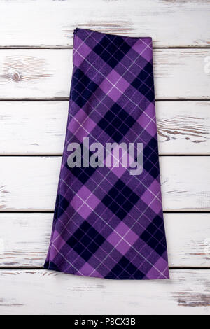 Folded woolen purple checkered skirt. Stock Photo