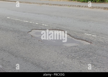 Pot holes in Carterton, Oxfordshire UK. 13th May 2018. UK Weather: Pot holes in West Oxfordshire, multiple potholes on the streets of Oxfordshire. Stock Photo