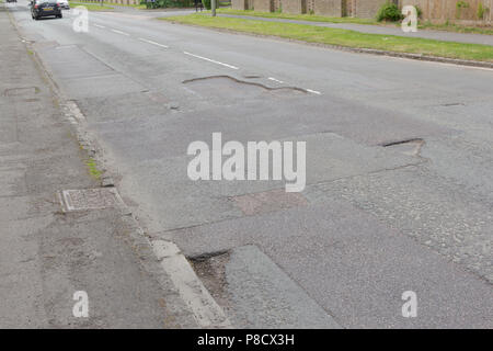 Pot holes in Carterton, Oxfordshire UK. 13th May 2018. UK Weather: Pot holes in West Oxfordshire, multiple potholes on the streets of Oxfordshire. Stock Photo