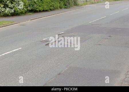 Pot holes in Carterton, Oxfordshire UK. 13th May 2018. UK Weather: Pot holes in West Oxfordshire, multiple potholes on the streets of Oxfordshire. Stock Photo