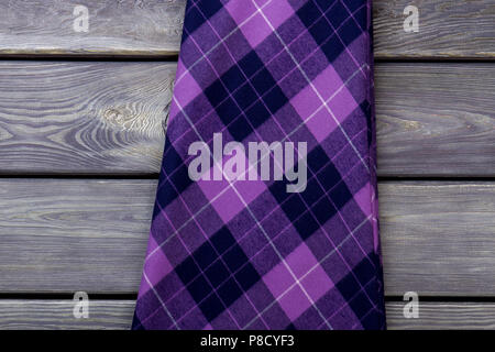 Close up checkered cloth material on wooden background. Stock Photo