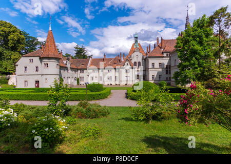 ancient castle with towers, bell tower and rose bushes in the foreground . For your design Stock Photo