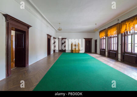 A wide corridor is conduced by a green path and parquet with many doors to other rooms and large windows to the street. . For your design Stock Photo