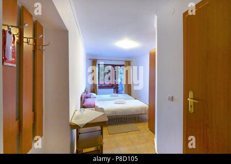 Double room in the hotel with a modern renovation and a beautiful view opening from the balcony to the beautiful nature around. . For your design Stock Photo