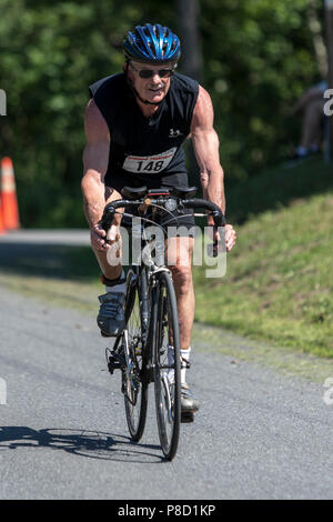 Male competitor in the bike segment in the 2018 Stissing Triathlon Stock Photo