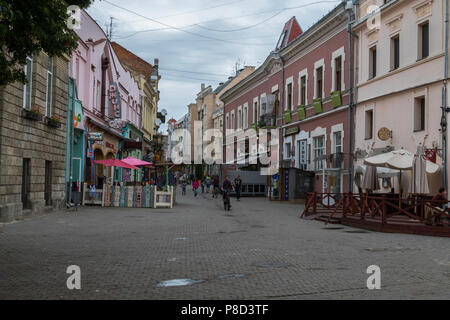 The street of the town is lined with a pavement and a large number of terraces near the cafe for vacationers . For your design Stock Photo