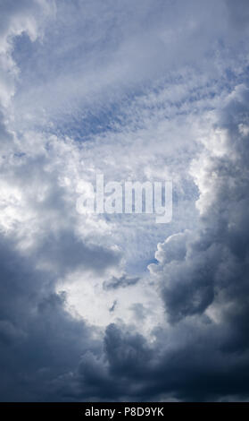 Background blue sky with gray cumulus clouds Stock Photo