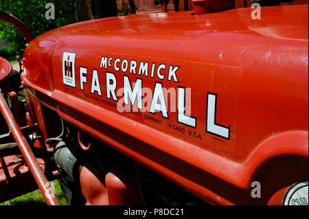 Well maintained, red McCormick Farmall farm tractor parked on farmstead in rural countryside of Wisconsin, USA Stock Photo
